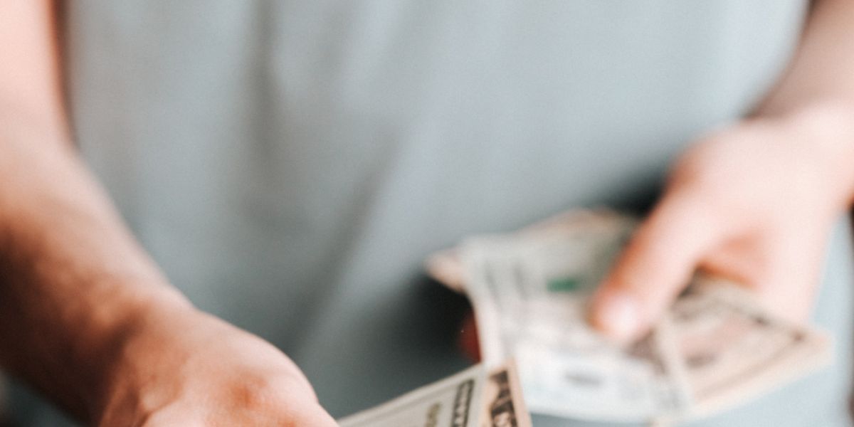 Free Crop man paying with American dollars Stock Photo