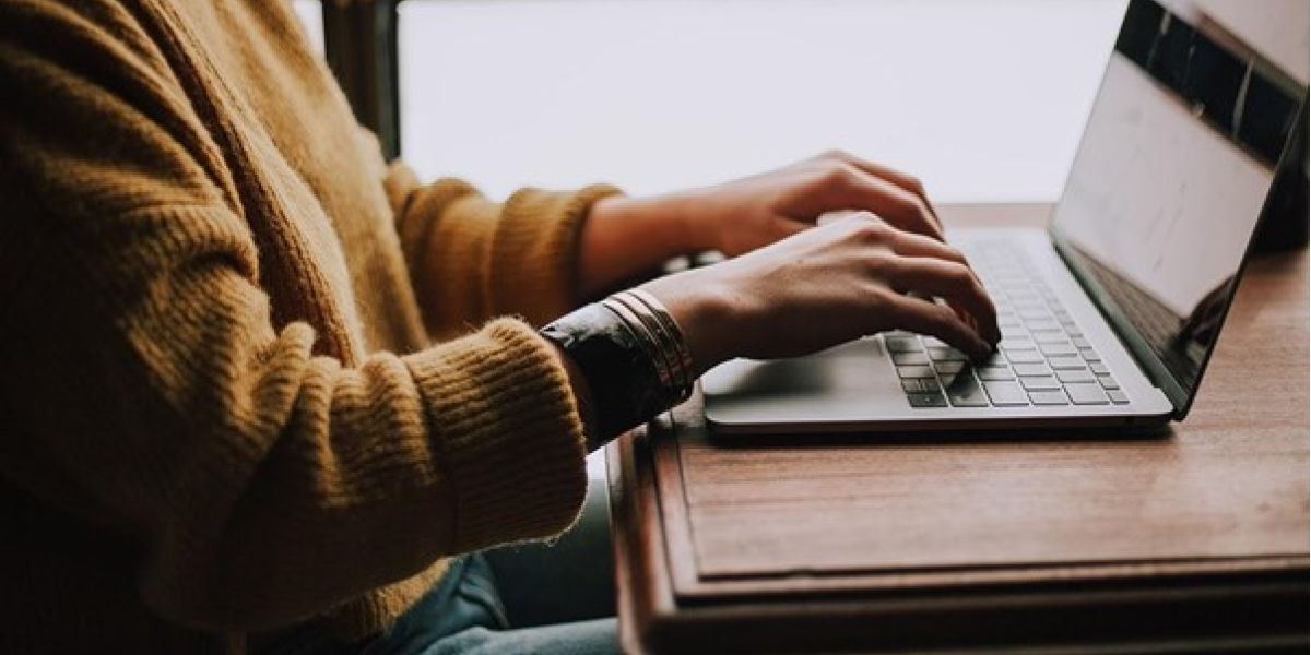 person sitting front of laptop