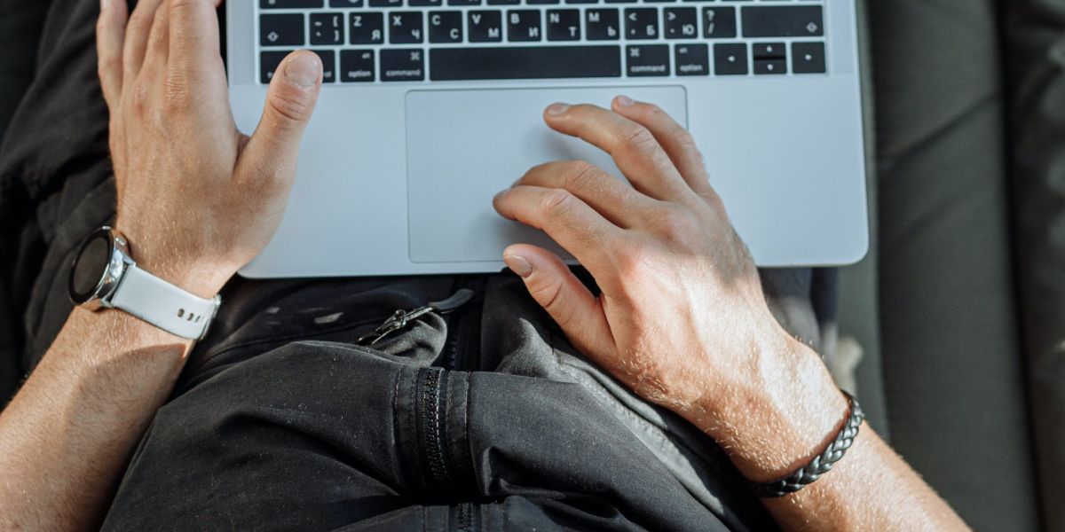 Free A Person Working on His Laptop Stock Photo