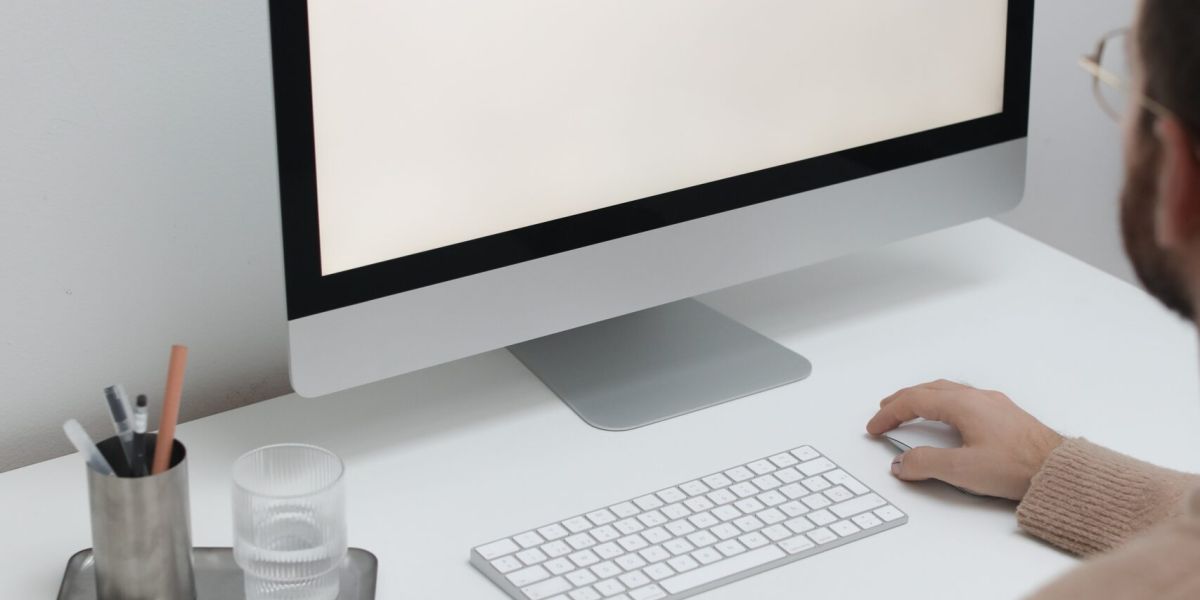 Free Crop man working on computer in workplace Stock Photo