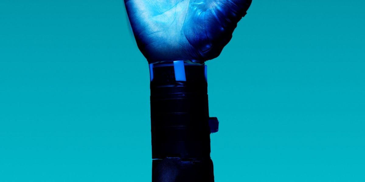 alt="Free Prosthetic Arm on Blue Background Stock Photo"