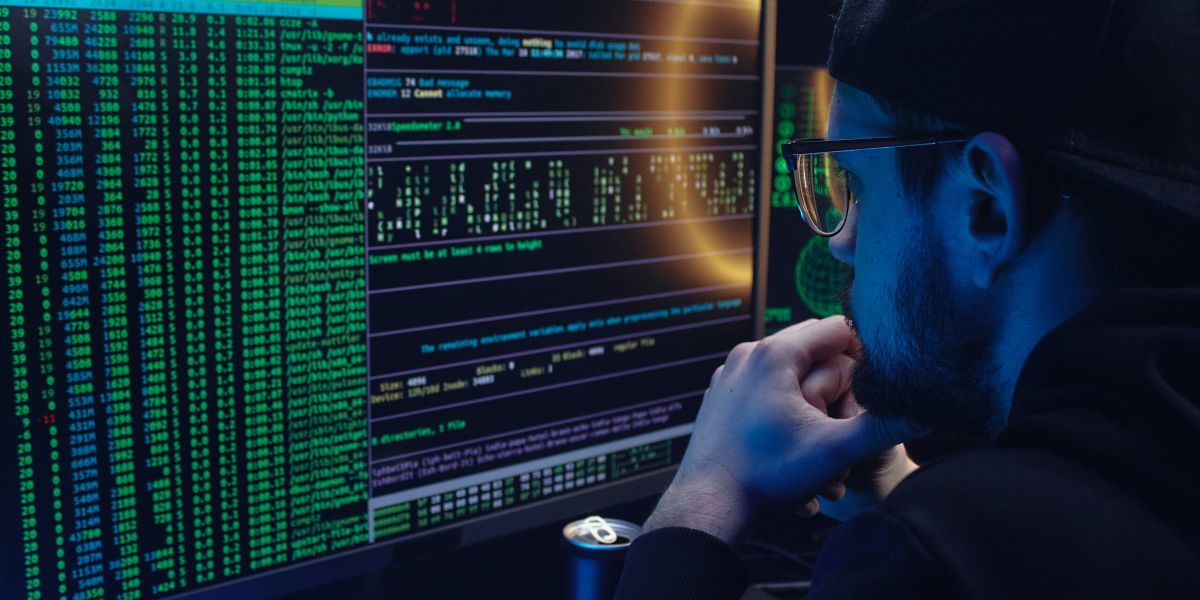 Free A Man Looking at a Computer Screen with Data Stock Photo